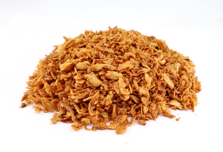 Heap of crispy fried onion pieces on white backgroundの写真素材