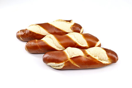 Loaves of bread with the recipe and texture of the soft Pretzel. White background.の写真素材