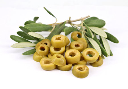 Green olives rings with leaves on white background.の写真素材