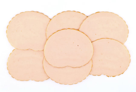 Slices of cold roasted chicken ham on white background.の写真素材
