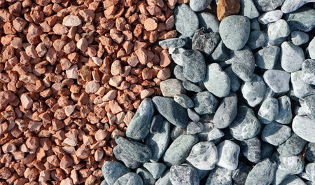Decorative pebbles used in the garden or yard. They are of two different varieties and colors. On the left small, rough and red ones, on the right gray. Background texturesの写真素材