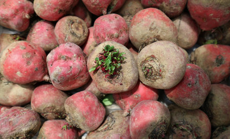 Red beetroot tubers on sale at the rural market. Top view, closeup