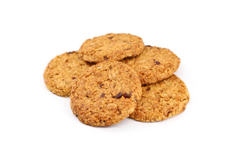 Cereal cookies with red berry fruits on white backgroundの写真素材