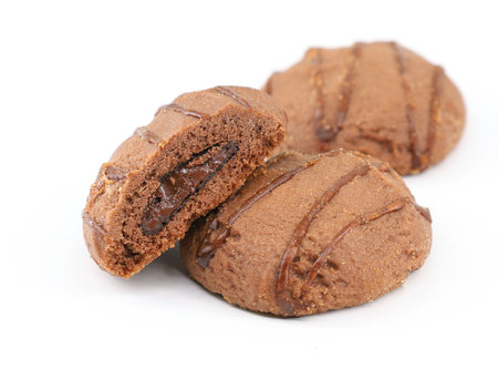 Round cocoa cookies filled with chocolate spread on white backgroundの写真素材