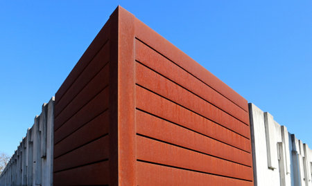 Modern surrounding wall made of rusted steel and concrete. Backgrounds and texturesの写真素材