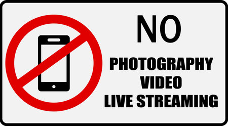 No photography, video or live streaming. Prohibition sign with a smartphone inside the ban circle and text.のイラスト素材
