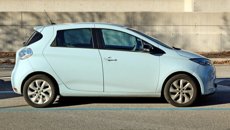 Udine, Italy. January 11, 2022. Side view of Zoe, full electric car of the french automaker Renault. Concrete wall background.のeditorial素材