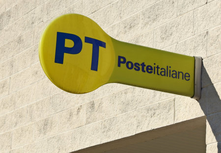 Udine, Italy. February 22, 2022. PT Poste Italiane sign outside a local city branch on a concrete brick wall . It is the brand of the Italian postal service provider.のeditorial素材
