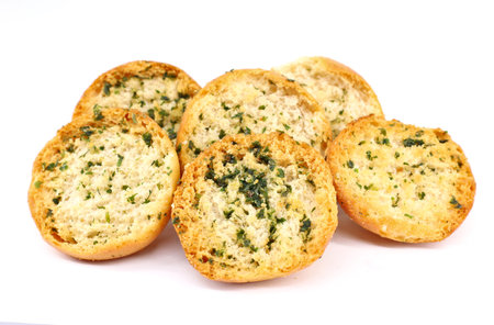 Crispbread with garlic, parsley and olive oil on white background.の写真素材