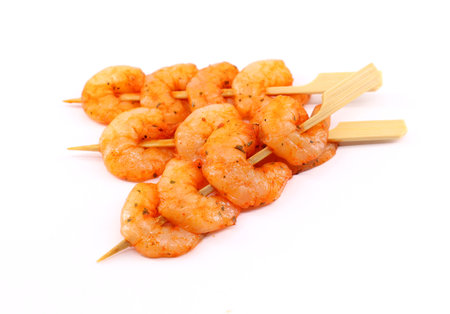 Skewers of spicy shrimp on a white background.の写真素材