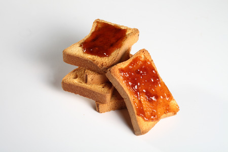 group of five biscuits with jam on a white backgroundの写真素材