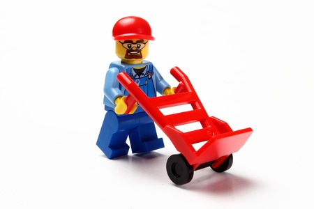 toy man whit hand truck on white backgroundの写真素材