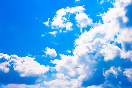 Beautiful big white clouds in front of blue sky background