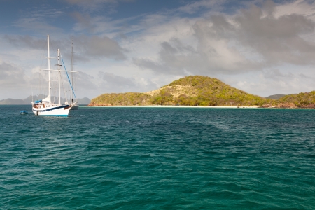 White yacht, blue water and cloudy blue sky. Amazing colours. Nera green island.の写真素材