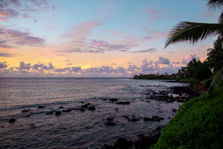 Tranquil Tropical Island Paradise Nature Scene of Maui Hawaii with Beautiful Crystal Clear Blue Water and Reflection of Colorful Sunset Sky and Palm Tree Silhouette in Scenic Backgの写真素材
