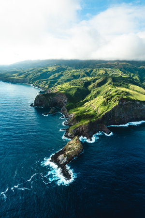 Beautiful Aerial View of Tropical Island Paradise Nature Scene of Maui Hawaii On Clear Sunshine Blue Sky Day with Vibrant Blue Ocean Water and Waves and Lush Green Mountain Scenicの写真素材