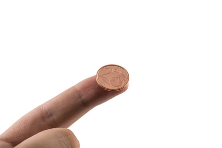 Two cents on the finger of a hand on a white background 