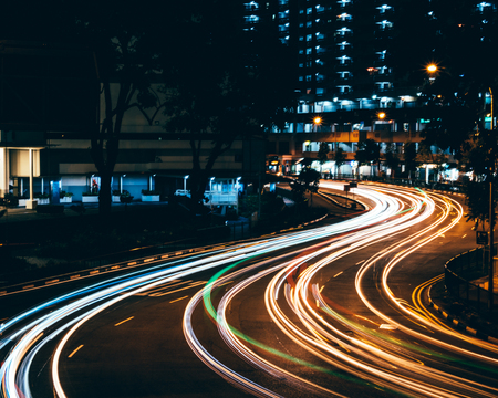 Fast light trail in the night with long exposure at Chinatown, Singapore