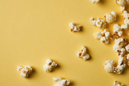 Popcorn on a yellow background.Copy space. Pop corn collection. Different sizes of popcornの写真素材