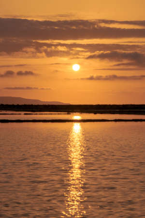 Sunset landscape of salt pans in traditional salt production in Trapani, Sicily, italy.の写真素材