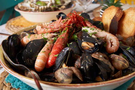 Delicious seafood mussels with shrimp and toast. Clams in the shells.Front view. Food concept. Italian restaurant.の写真素材