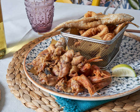 Fried fish dish with squid, shrimp and small octopus. Italian restaurant. Food concept