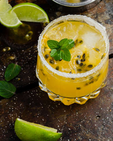 Fresh and Tropical cocktail with passion fruit, lime, mint and ice. Cold summer drink. Beverages and drink concept.の写真素材