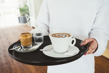 unrecognizable waitress holding a breakfast tray at a coffee shopの写真素材