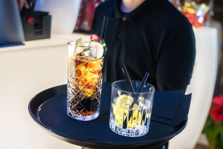 unrecognizable waiter ready to serve different drinks on a tray