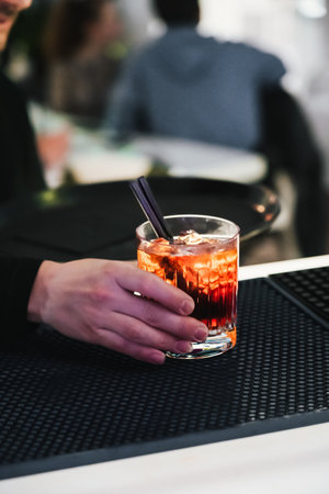 unrecognizable waiter preparing cocktails ready on the bar counter for delivery.の写真素材