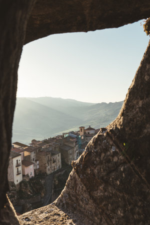 Sunset over Sperlinga village viewed through a stone window in Sicilyの写真素材