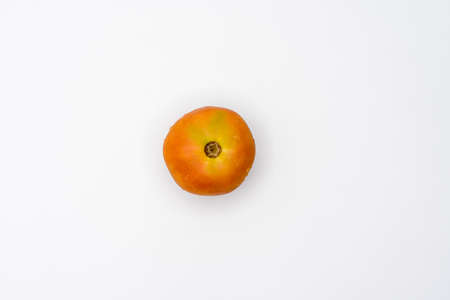 Tomato with droplets of water, close-up, viewed from directly above