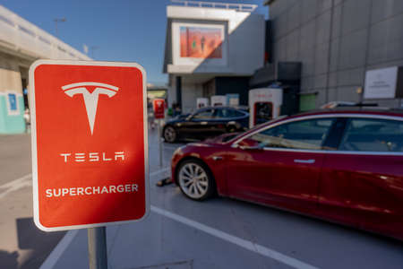 MURCIA, SPAIN - FEBRUARY 2, 2021: Two electric vehicles are parked in charging station of Tesla brand. This station has 10 Superchargers, always available and up to 150 kWのeditorial素材