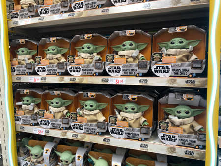 MURCIA, SPAIN - NOVEMBER 2, 2021: Many dolls from the TV series The Mandalorian on supermarket stand. The famous character The Child became known in the first season of the series The Mandalorian which is a television product of Star Wars saga produced byのeditorial素材
