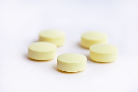 yellow pills isolated on whiteの写真素材