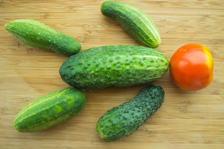 cucumber and tomato on wooden tableの写真素材