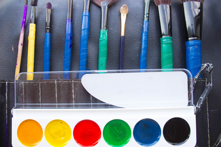 watercolor paint and brushes on wooden textureの写真素材