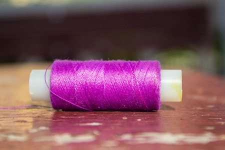 purple thread on the tableの写真素材