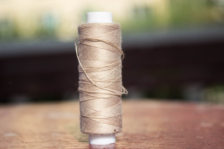 gray thread on a brown table