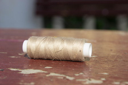gray thread on a brown table