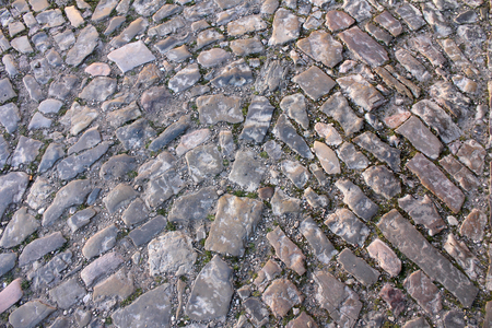 Vintage cobblestone pavement, old road of stone blocksの写真素材