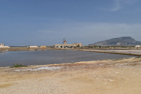 Trapani, Sicily, Italy - April 26 2018: Beautiful view of Culcasi saline with salt tanks, white heaps of salt and a windmillのeditorial素材