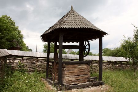 Secular fountain and wall of wood, specific for Transylvaniaの写真素材