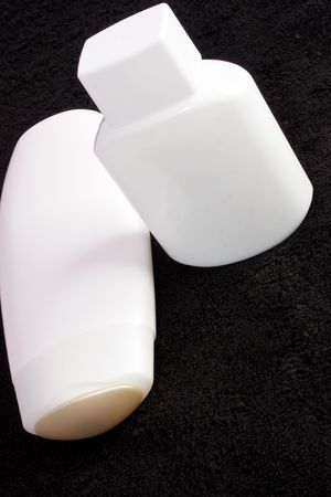 Cosmetic containers on black towelの写真素材
