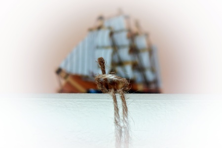 Old paper with a possible message and wooden ship in backgroundの写真素材