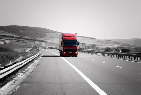 Red truck on highway is moving rapidly Red truck on highway is moving rapidly