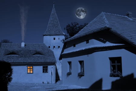 Exterior of ghostly corner from medieval city under the moonlightの写真素材