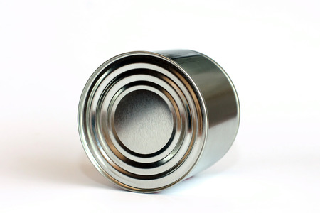 Overturned metallic can on white background