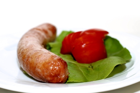 Grilled sausage with green salad and tomatoの写真素材