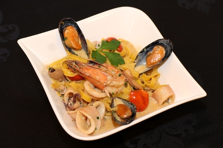 Clams with shrimps on white plateの写真素材